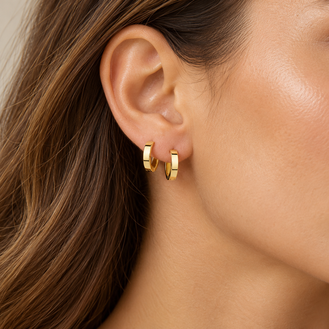 14K yellow gold polished hoop earrings 12 mm and 15 mm size comparison on model